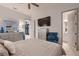 Chic bedroom showcasing a dresser with TV, stylish decor, and access to the en-suite bathroom at 4087 Villa Rafael Dr, Las Vegas, NV 89141