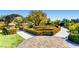 Beautiful community garden featuring manicured hedges, paved walkways, and various ornamental trees at 4087 Villa Rafael Dr, Las Vegas, NV 89141