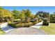 Serene community garden featuring manicured hedges, paved walkways, and various ornamental trees at 4087 Villa Rafael Dr, Las Vegas, NV 89141