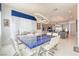 The dining room features a unique blue-toned dining table, modern lighting, and elegant decor at 4087 Villa Rafael Dr, Las Vegas, NV 89141