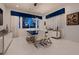 Modern dining room with seating for six and a contemporary light fixture at 4087 Villa Rafael Dr, Las Vegas, NV 89141