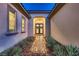 Inviting home entrance with a brick walkway and beautiful landscaping at 4087 Villa Rafael Dr, Las Vegas, NV 89141