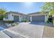 Charming single-story home with well-maintained landscaping and a wide paver driveway leading to two garages at 4087 Villa Rafael Dr, Las Vegas, NV 89141