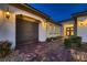 Inviting home exterior with manicured landscaping, paver driveway, and a well-lit, double-door entryway at 4087 Villa Rafael Dr, Las Vegas, NV 89141