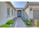 Inviting home exterior with manicured landscaping, paver walkway, and a well-lit, double-door entryway at 4087 Villa Rafael Dr, Las Vegas, NV 89141