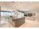 A stylish, open-concept kitchen featuring modern pendant lighting, a spacious island, and bright white flooring at 4087 Villa Rafael Dr, Las Vegas, NV 89141