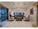 Elegant living room with marble floors, stylish seating, and bright natural light from large sliding doors at 4087 Villa Rafael Dr, Las Vegas, NV 89141