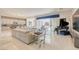 Bright living room boasts tile floors, sleek furniture, piano, and natural light from the sliding glass doors at 4087 Villa Rafael Dr, Las Vegas, NV 89141