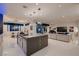 Open-concept living space with modern lighting, a spacious island, and luxurious finishes at 4087 Villa Rafael Dr, Las Vegas, NV 89141