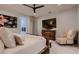 Comfortable main bedroom with a ceiling fan, a wall-mounted TV, and marble tile flooring at 4087 Villa Rafael Dr, Las Vegas, NV 89141