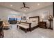 Spacious main bedroom boasts seating area, ceiling fan, and marble-patterned floors at 4087 Villa Rafael Dr, Las Vegas, NV 89141