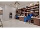Large home office features built-in bookcases and dual desks with blue chairs at 4087 Villa Rafael Dr, Las Vegas, NV 89141