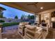 Inviting covered outdoor patio with comfortable seating and a view of the backyard at 4087 Villa Rafael Dr, Las Vegas, NV 89141