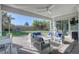 Covered outdoor patio with comfortable seating, a ceiling fan, and a view of the landscaped backyard at 4087 Villa Rafael Dr, Las Vegas, NV 89141