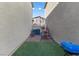 Artificial grass backyard featuring a small paver patio and partial view of a fence at 4371 Fire Glow Ave, North Las Vegas, NV 89084