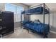 This bedroom features a bunk bed, large window with blinds, and carpeted floor at 4371 Fire Glow Ave, North Las Vegas, NV 89084