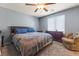 Inviting bedroom with a comfortable bed, ceiling fan, and plenty of natural light at 4371 Fire Glow Ave, North Las Vegas, NV 89084