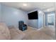 Cozy bonus room with plush seating and a large wall-mounted television for entertainment at 4371 Fire Glow Ave, North Las Vegas, NV 89084
