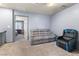Comfortable bonus room showcasing a cozy seating arrangement and a view into the bedroom at 4371 Fire Glow Ave, North Las Vegas, NV 89084