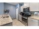 Bright kitchen featuring granite countertops, stainless steel appliances, and tile floors at 4371 Fire Glow Ave, North Las Vegas, NV 89084