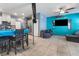 View of the open concept living area with tile floors, ceiling fan, and blue accent wall at 4371 Fire Glow Ave, North Las Vegas, NV 89084