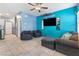 Living area with tile floors, gray seating, and blue accent wall at 4371 Fire Glow Ave, North Las Vegas, NV 89084