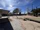 Large backyard featuring a mix of paved areas, natural landscaping, and mature shade trees at 4485 Greenhill Dr, Las Vegas, NV 89121