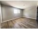 Bedroom featuring light wood floors and a large window providing natural light at 4485 Greenhill Dr, Las Vegas, NV 89121
