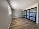 Cozy bedroom featuring wood floors, large sliding closet doors and a window at 4485 Greenhill Dr, Las Vegas, NV 89121