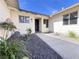 Charming home entrance featuring a walkway, rock garden, and well-maintained landscaping at 4485 Greenhill Dr, Las Vegas, NV 89121