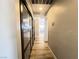 Hallway with wooden floors, closet with mirror doors, and neutral colored walls at 4485 Greenhill Dr, Las Vegas, NV 89121
