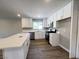 Well-equipped kitchen featuring an island, white cabinets, and stainless steel appliances at 4485 Greenhill Dr, Las Vegas, NV 89121