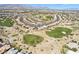 An aerial shot of a community featuring a golf course and single Gathering homes in a desert landscape at 4963 Pensier St, Las Vegas, NV 89135
