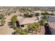 An aerial view of a single Gathering home with mature trees, a tile roof, and a covered patio at 4963 Pensier St, Las Vegas, NV 89135