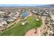 Wide aerial view of the golf course community, highlighting the lush green fairways and surrounding homes at 4963 Pensier St, Las Vegas, NV 89135