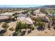 An aerial view of a well-maintained home featuring desert landscaping and a tile roof in a golf course community at 4963 Pensier St, Las Vegas, NV 89135