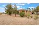 Rear exterior showcasing desert landscaping and neutral exterior finishes, harmonizing with the natural surroundings at 4963 Pensier St, Las Vegas, NV 89135
