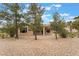 Back of the property with desert landscaping, offering a low-maintenance and natural aesthetic at 4963 Pensier St, Las Vegas, NV 89135