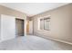 Bedroom featuring plush carpet, closet, window, and neutral paint at 4963 Pensier St, Las Vegas, NV 89135