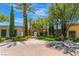 Clubhouse entrance surrounded by lush landscaping and mature trees at 4963 Pensier St, Las Vegas, NV 89135
