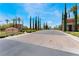 Inviting community entrance with meticulous landscaping and signature signage under a clear, sunny sky at 4963 Pensier St, Las Vegas, NV 89135