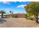Tan home with desert landscaping, mature trees, and a tile roof under a sunny blue sky at 4963 Pensier St, Las Vegas, NV 89135