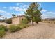 Home exterior with desert landscaping, mature trees, and scenic view at 4963 Pensier St, Las Vegas, NV 89135