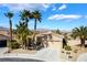 Charming single-story home with desert landscaping and palm trees, complemented by a spacious two-car garage at 4963 Pensier St, Las Vegas, NV 89135