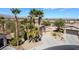 Inviting single-story home with mature palm trees, low maintenance landscaping, a wide driveway and two-car garage at 4963 Pensier St, Las Vegas, NV 89135