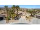 Picturesque single-story home featuring desert landscaping and palm trees, a wide driveway, and a two-car garage at 4963 Pensier St, Las Vegas, NV 89135