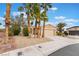 Inviting home with palm trees, low-maintenance yard, and a two-car garage at 4963 Pensier St, Las Vegas, NV 89135