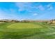 Golf course with rolling green hills under a blue sky, offering a scenic view and recreational opportunity at 4963 Pensier St, Las Vegas, NV 89135