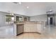 Bright and open kitchen featuring stainless steel appliances, tile floors and a peninsula at 4963 Pensier St, Las Vegas, NV 89135