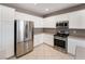 Bright kitchen featuring white cabinets and stainless steel appliances at 4963 Pensier St, Las Vegas, NV 89135